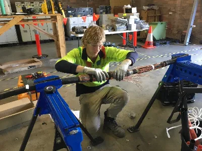 a student in high visibility clothing working on a polymeric cable for UETDRDU013- Joint, Terminate and Maintain High Voltage Underground Polymeric Cable